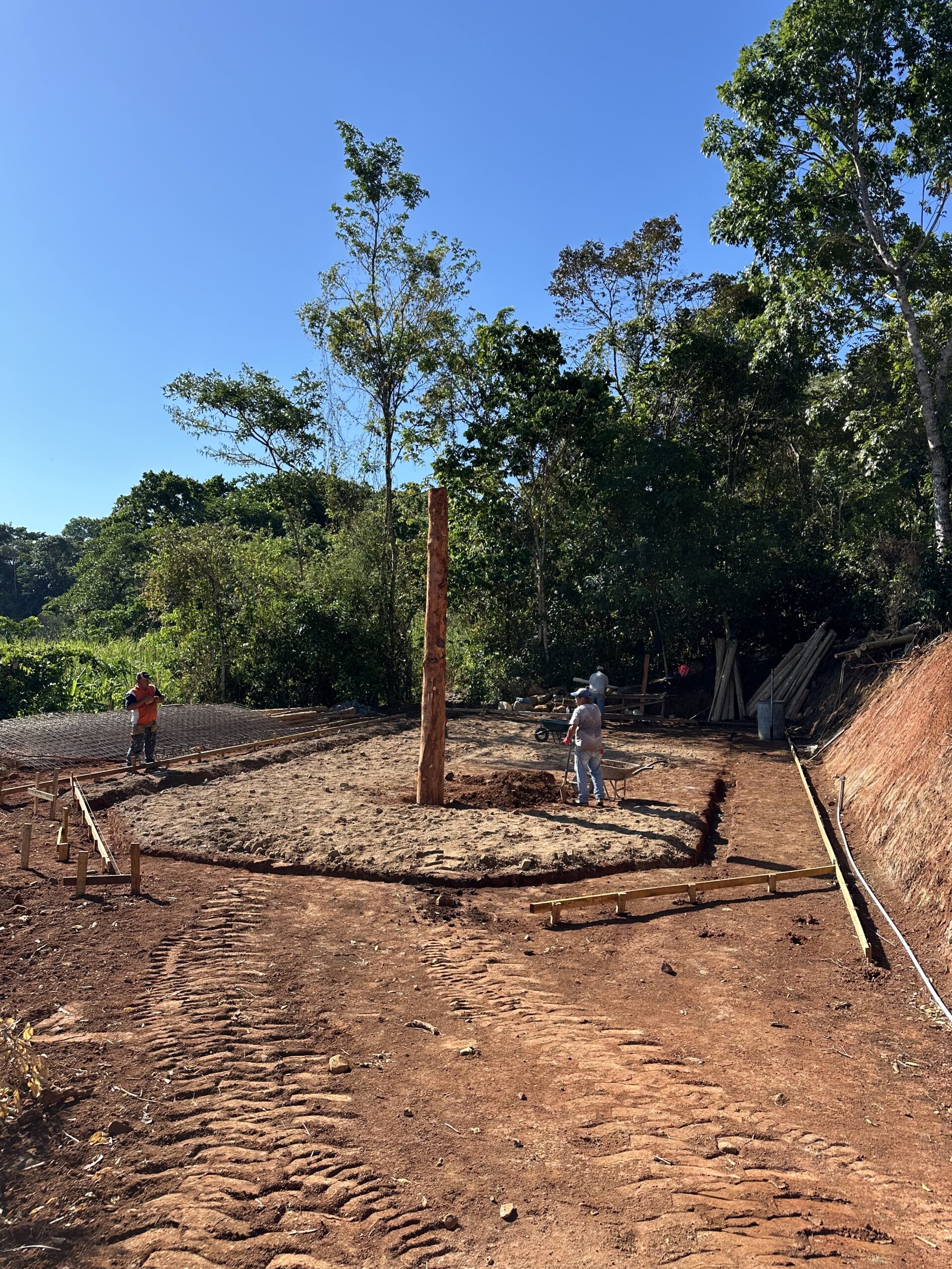 Site preparation and foundation work surrounded by forest in Puriscal