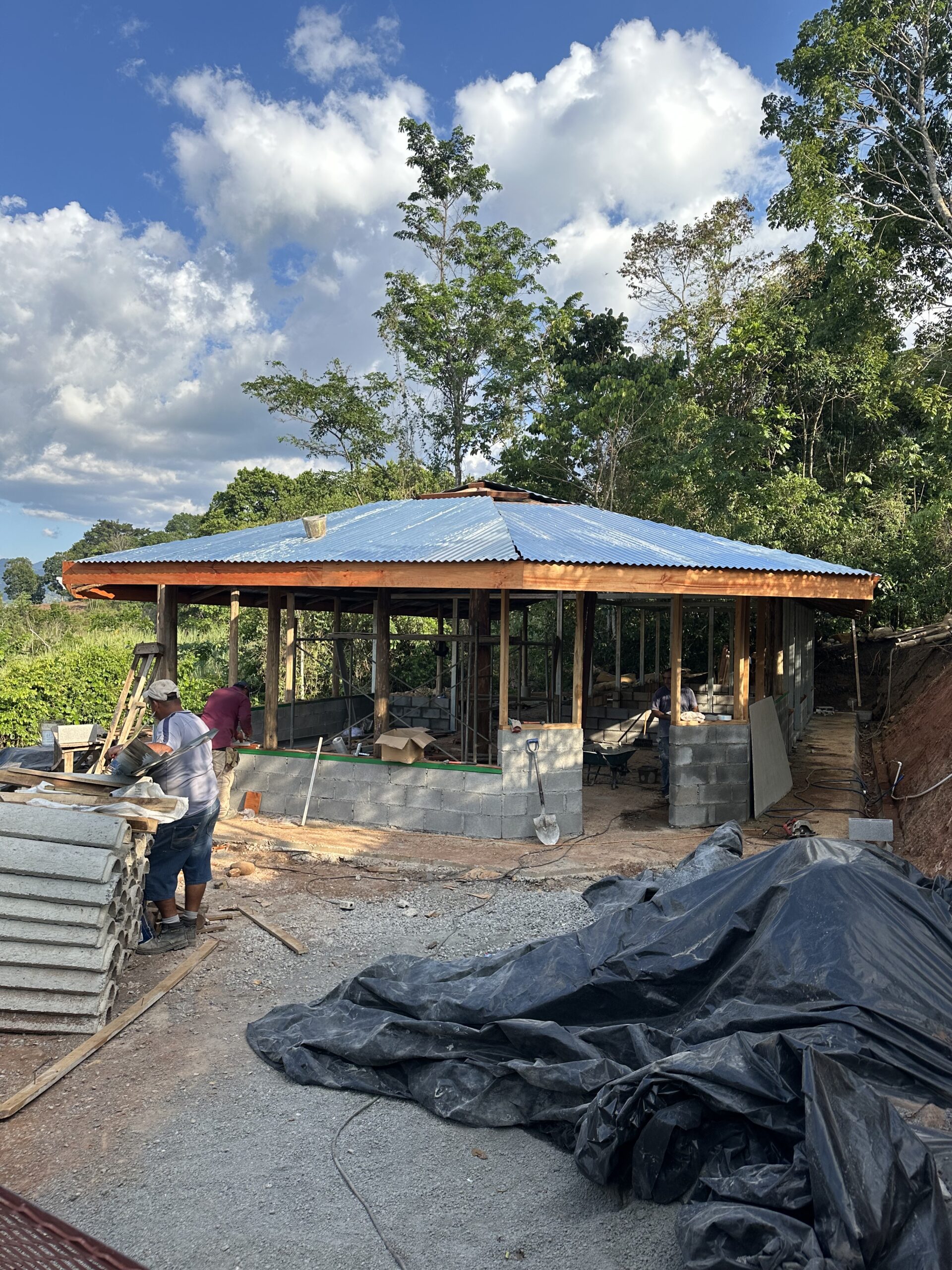 Timber roof under construction beneath a blue sky