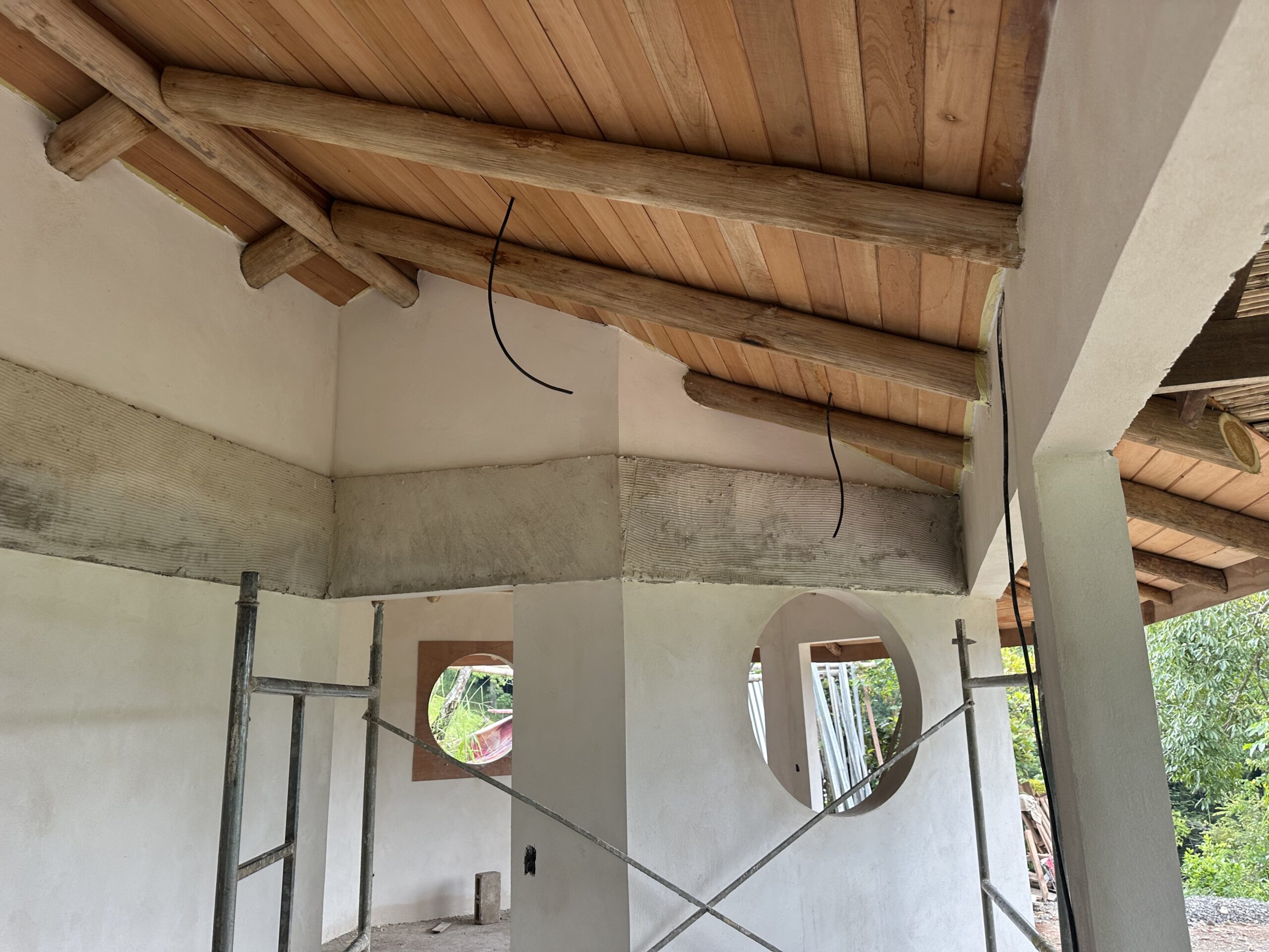 Interior plasterwork with circular openings and exposed timber ceiling