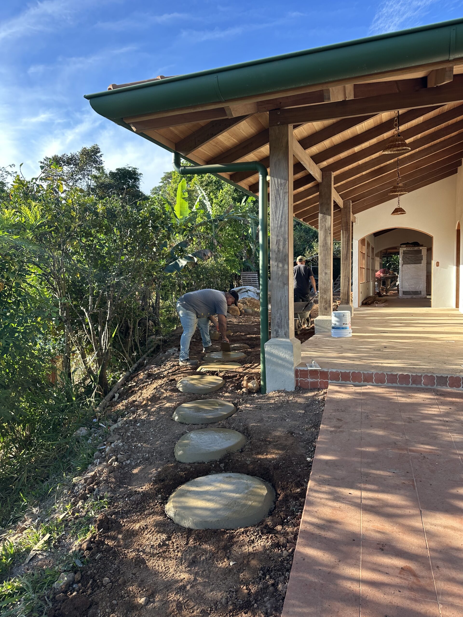 Covered timber veranda and garden path being completed
