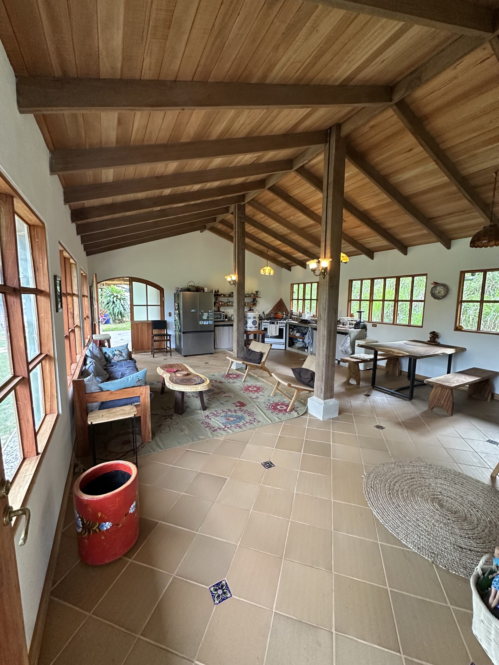 Finished open-plan living room and kitchen beneath a timber ceiling