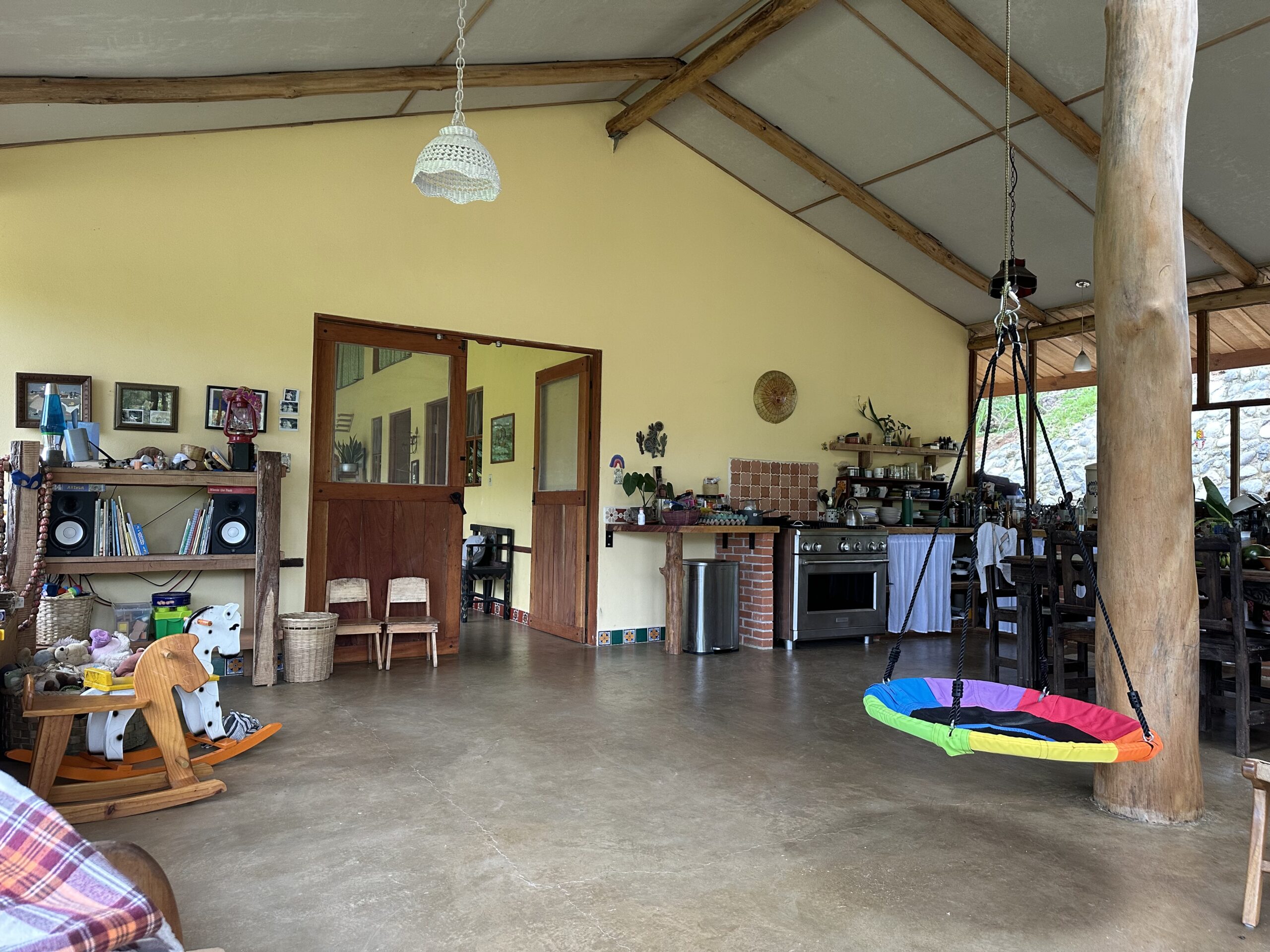 Completed open living and kitchen space with exposed timber beams