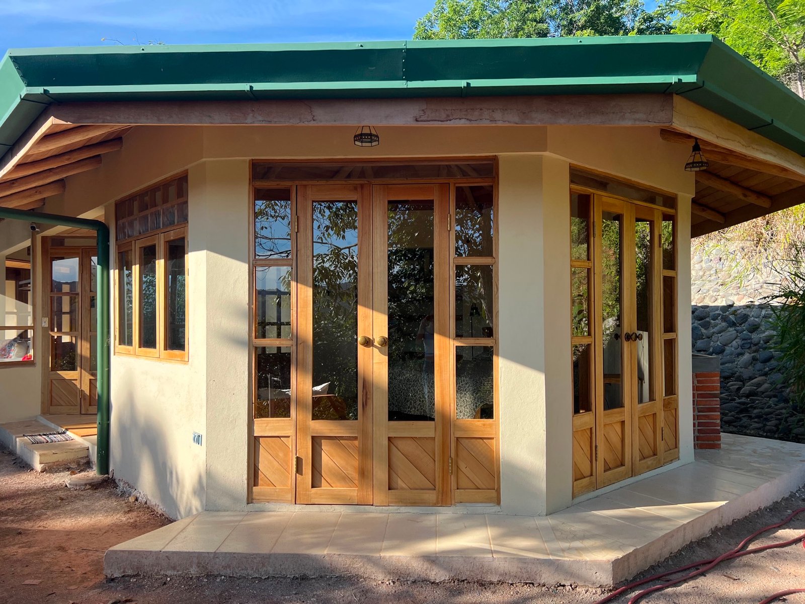 Completed exterior and handmade timber doors of the Round-Window Home