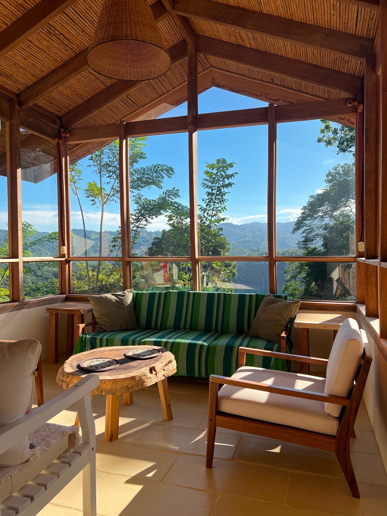 Timber-framed sitting room overlooking the mountains of Puriscal