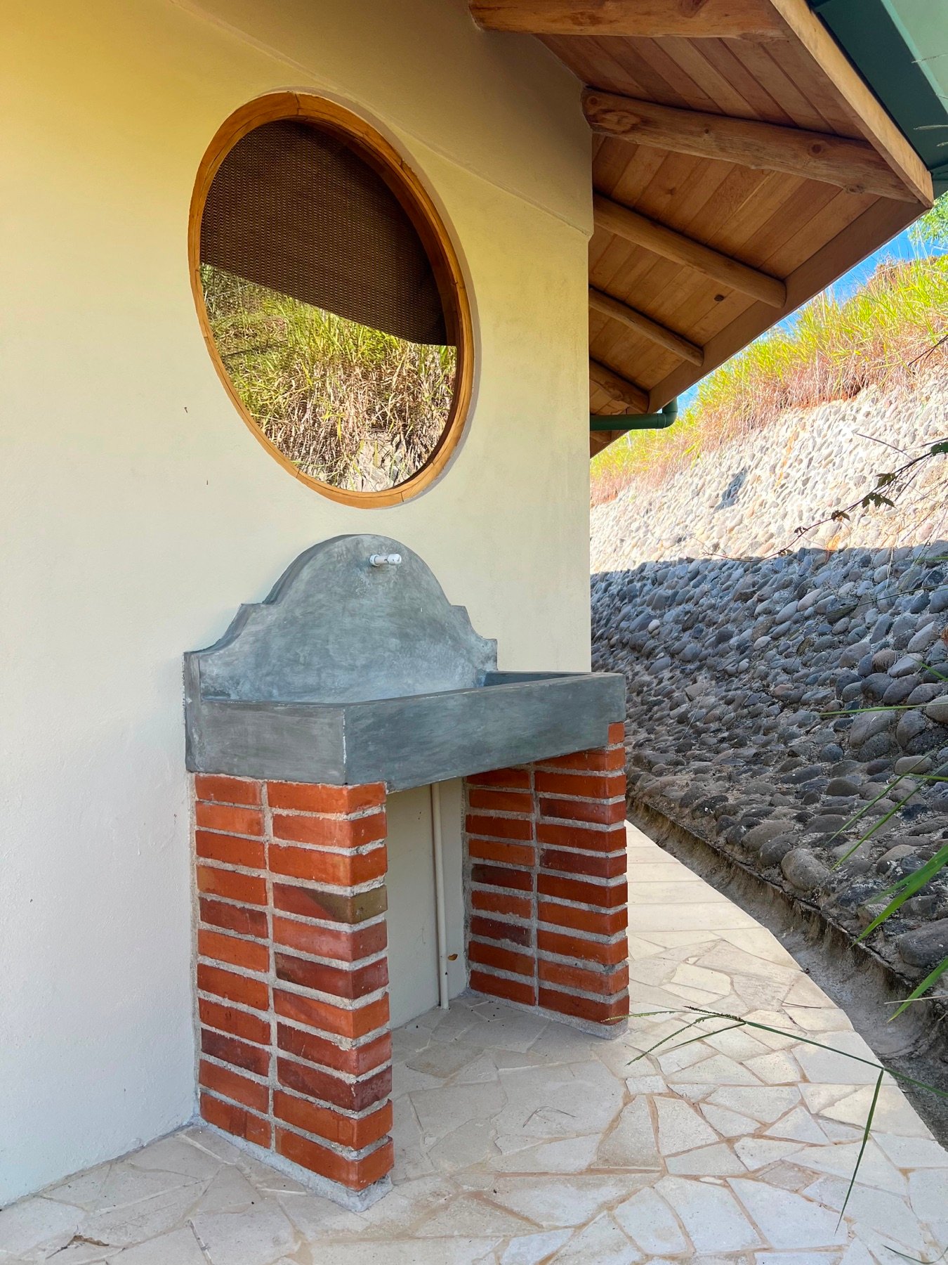 Circular window and handcrafted outdoor wash basin